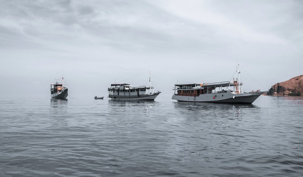 Sea Boats On Misty Ocean
