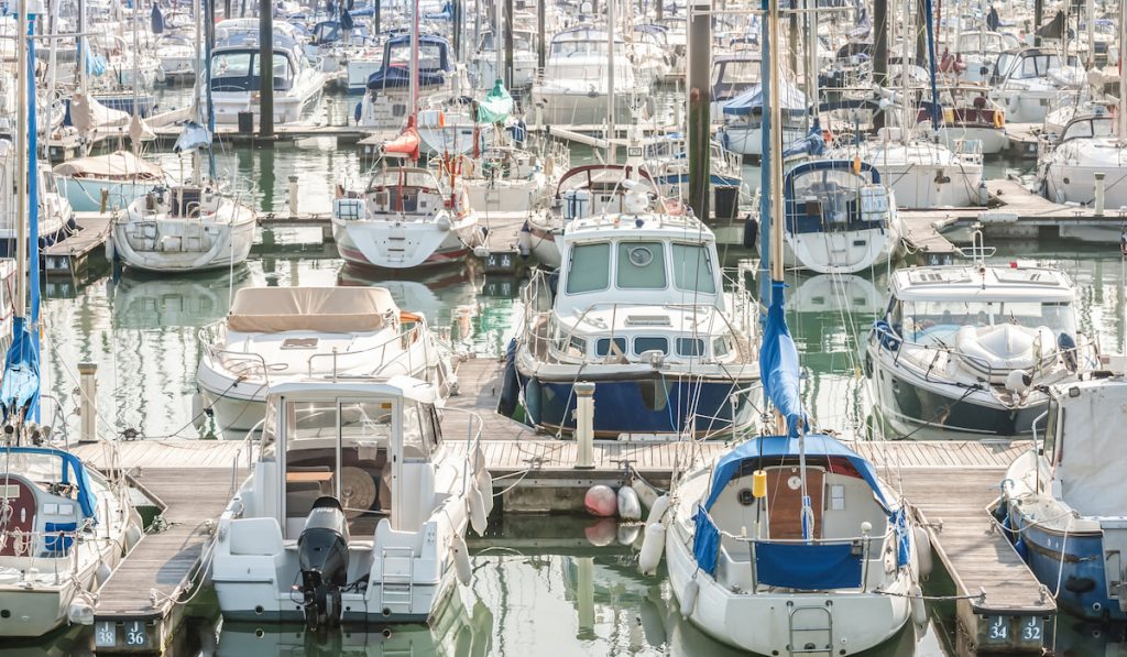 crowded boating marina with lots of yachts and small motorboats