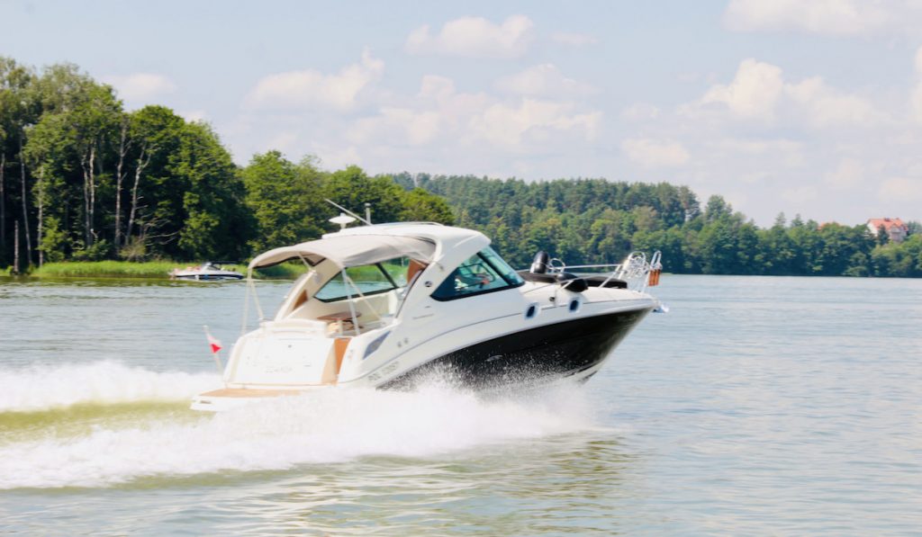 speedboat on lakeshore during summertime 